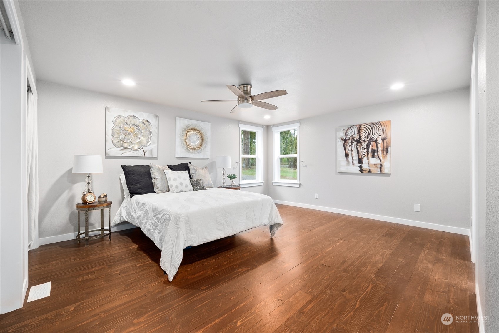 661 Brockway Road Chehalis, WA 98532 - Photo 20 of 40 a spacious bedroom with a large bed and a chandelier