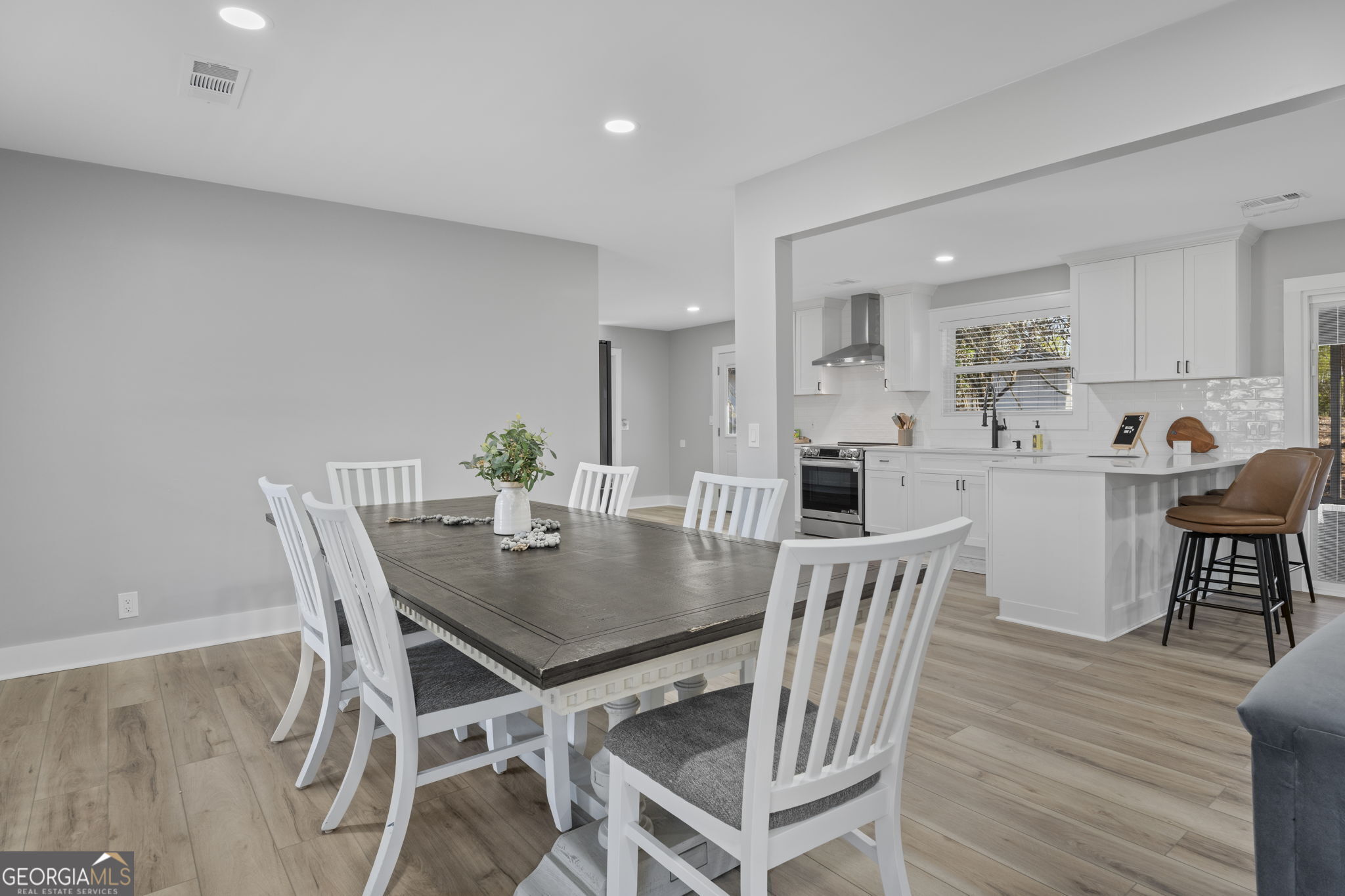 2604 Flat Shoals Road Southwest Conyers, GA 30094 - Photo 13 of 44 a view of a dining room with furniture and wooden floor
