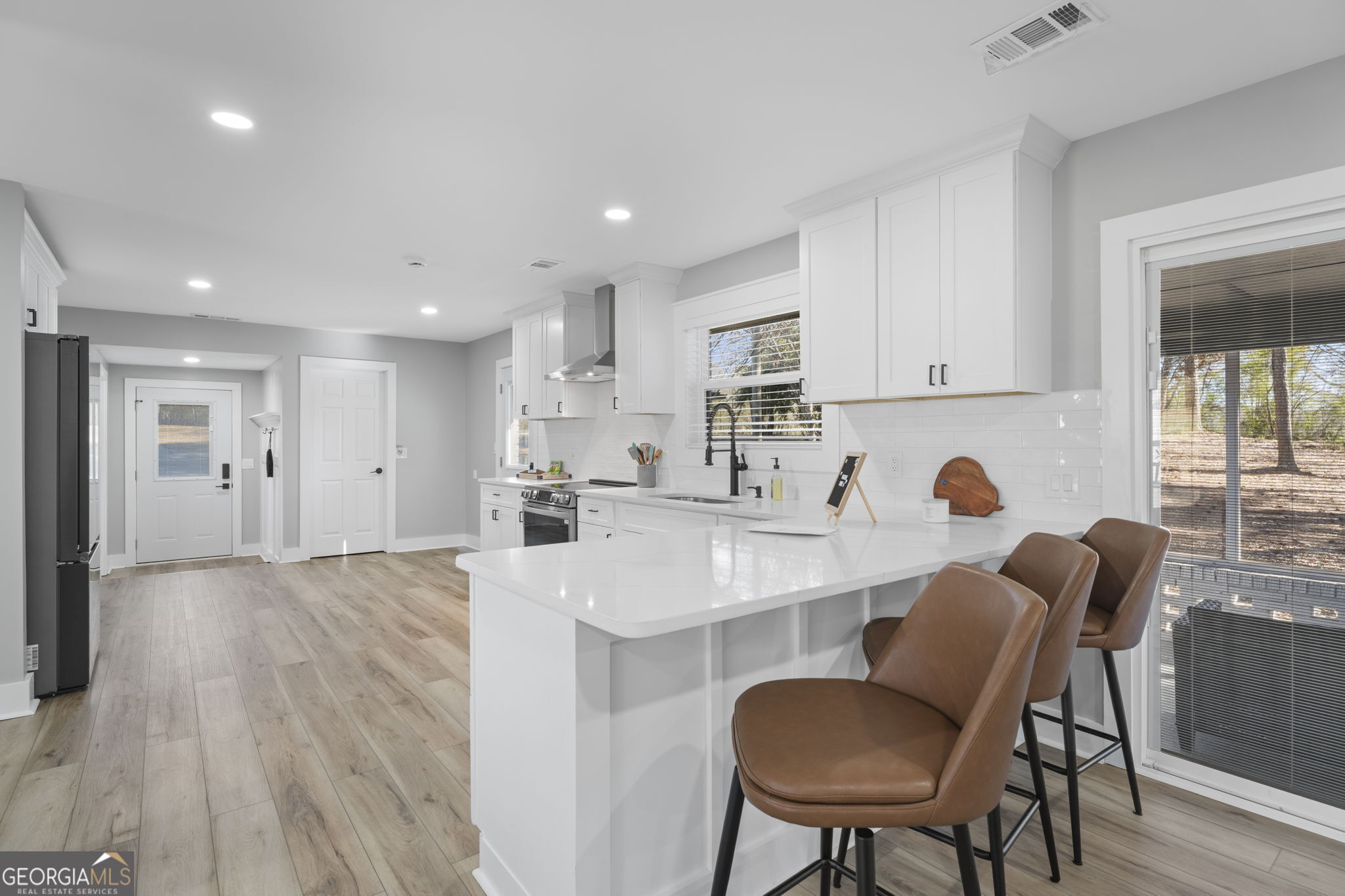 2604 Flat Shoals Road Southwest Conyers, GA 30094 - Photo 17 of 44 a large white kitchen with sink and cabinets