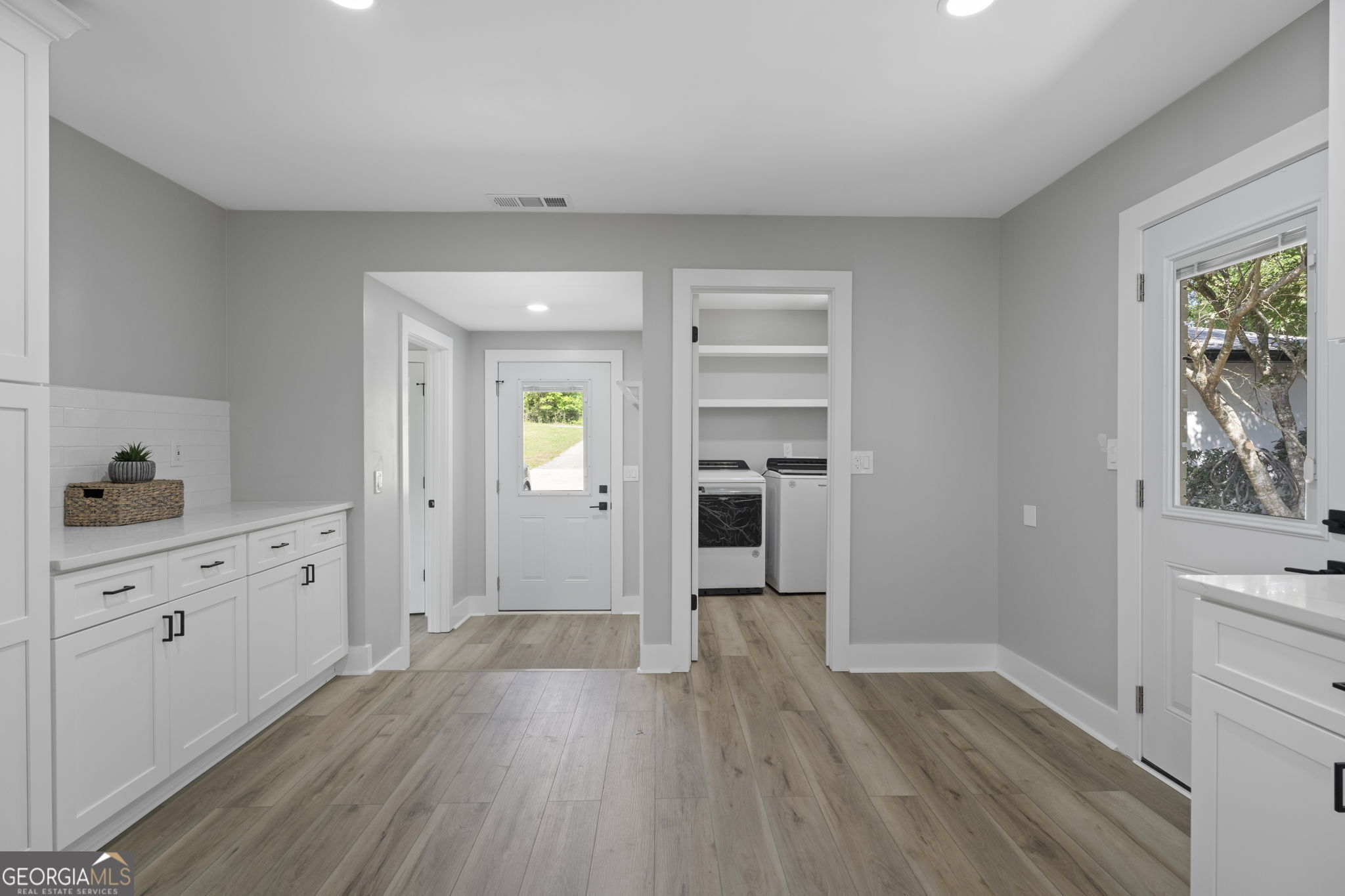 2604 Flat Shoals Road Southwest Conyers, GA 30094 - Photo 21 of 44 a big room with wooden floor and cabinet