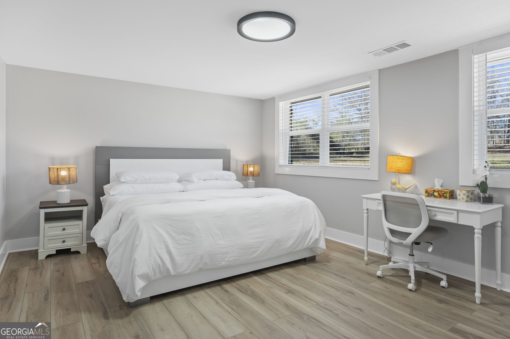 2604 Flat Shoals Road Southwest Conyers, GA 30094 - Photo 24 of 44 a bedroom with a bed a chair and a window