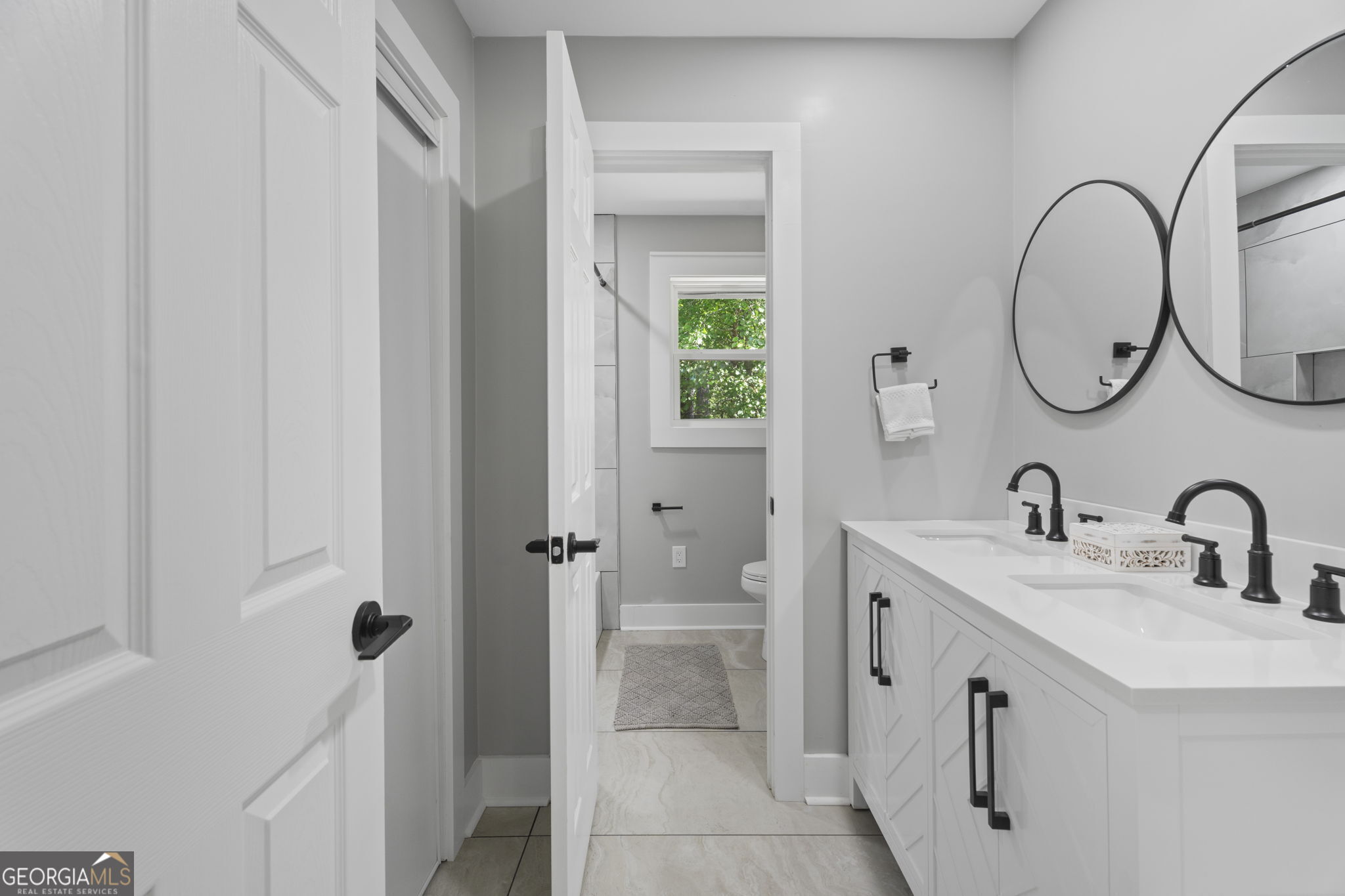 2604 Flat Shoals Road Southwest Conyers, GA 30094 - Photo 26 of 44 a bathroom with a double vanity sink mirror and a toilet