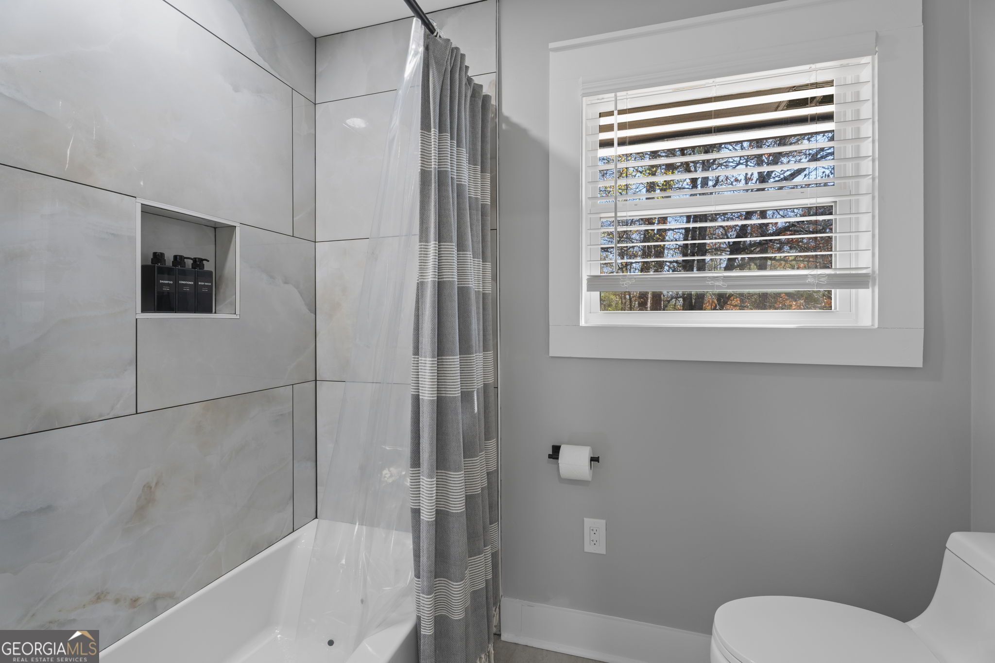 2604 Flat Shoals Road Southwest Conyers, GA 30094 - Photo 28 of 44 a bathroom with a toilet and a shower