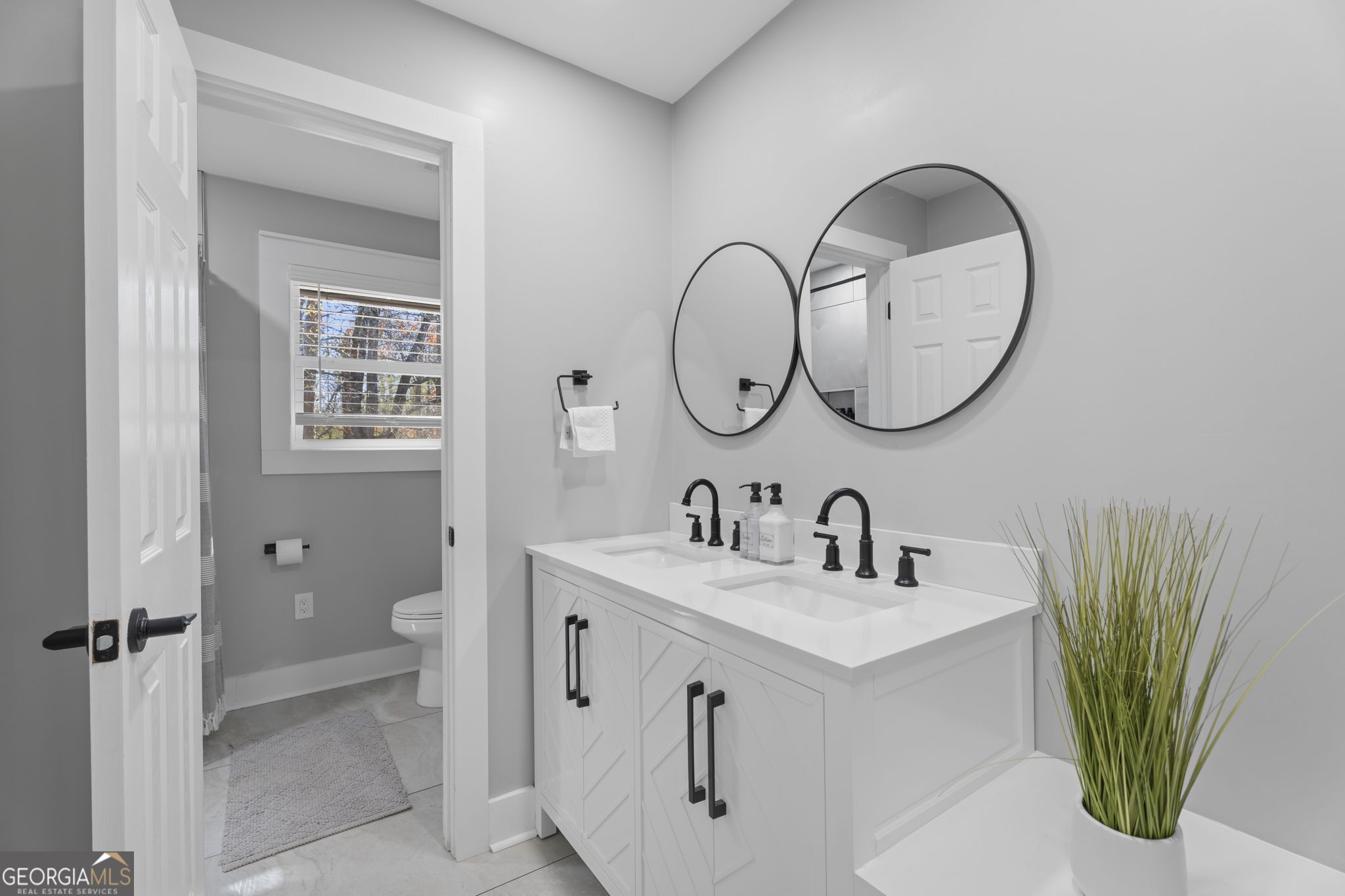 2604 Flat Shoals Road Southwest Conyers, GA 30094 - Photo 29 of 44 a bathroom with a sink and a mirror