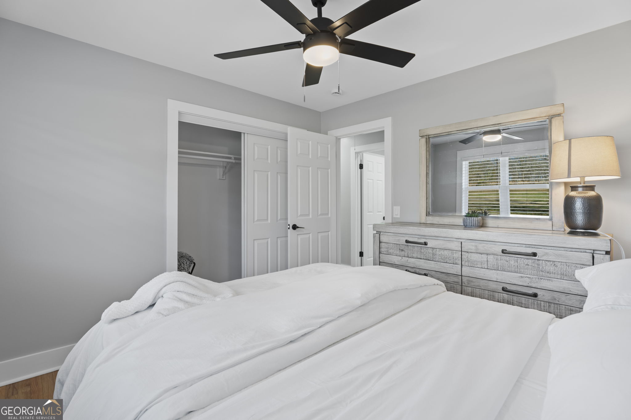 2604 Flat Shoals Road Southwest Conyers, GA 30094 - Photo 30 of 44 a bedroom with a large bed and a chandelier