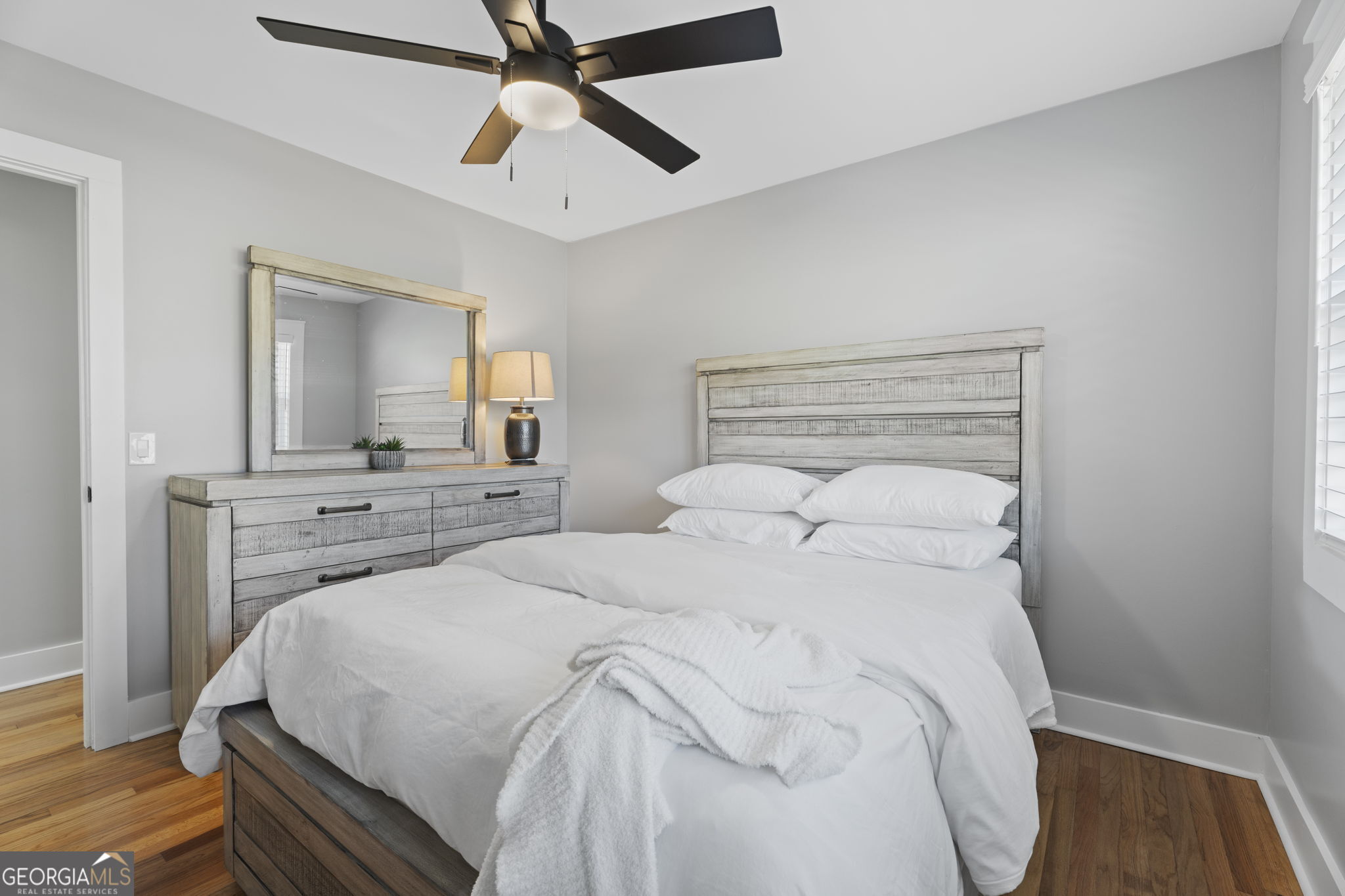 2604 Flat Shoals Road Southwest Conyers, GA 30094 - Photo 31 of 44 a bedroom with a large bed and a chandelier