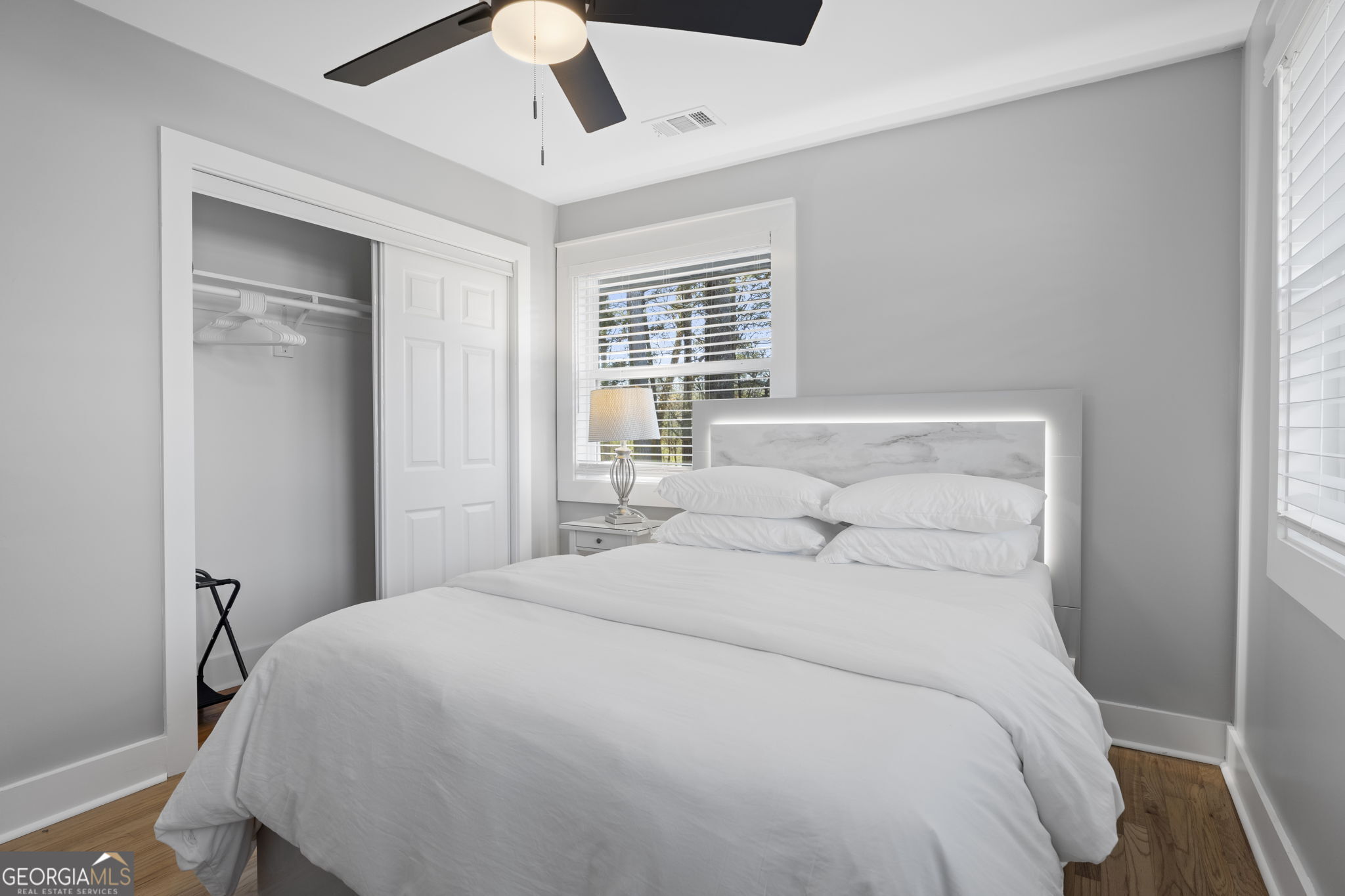 2604 Flat Shoals Road Southwest Conyers, GA 30094 - Photo 32 of 44 a bedroom with a large bed and a chandelier