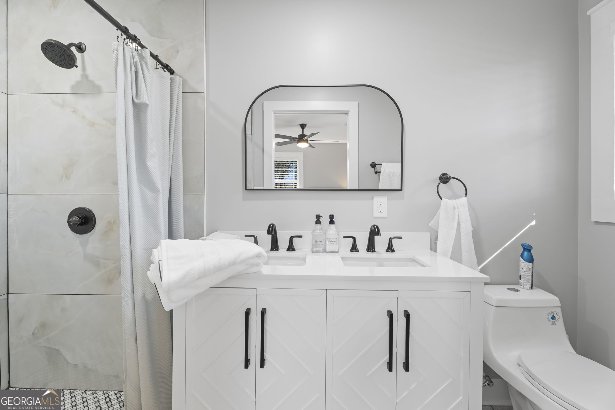 2604 Flat Shoals Road Southwest Conyers, GA 30094 - Photo 36 of 44 a bathroom with a granite countertop sink a toilet and a mirror