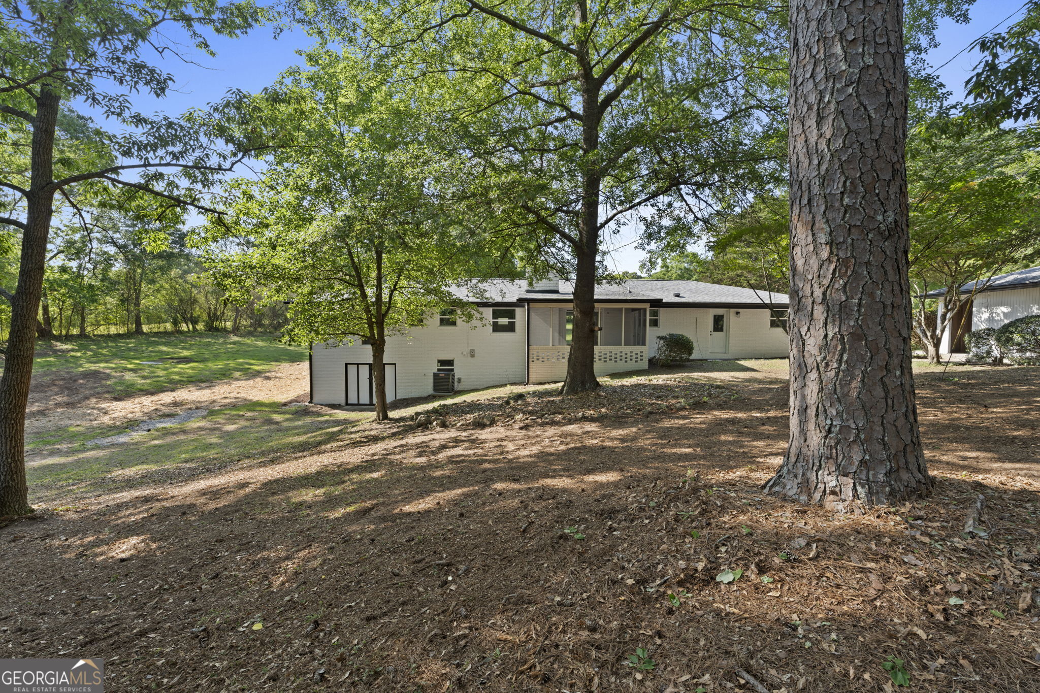 2604 Flat Shoals Road Southwest Conyers, GA 30094 - Photo 39 of 44 a view of a yard with a tree