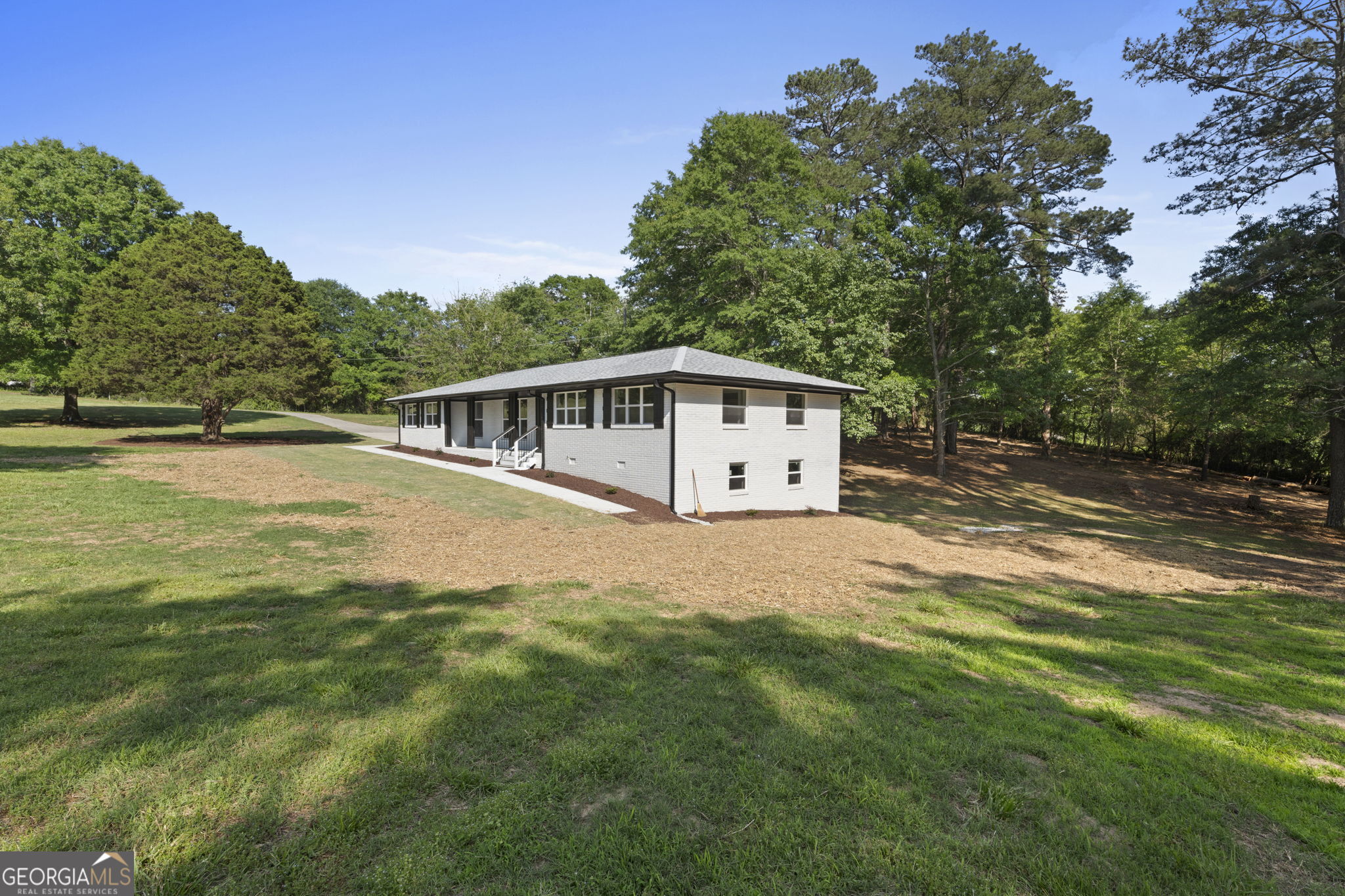 2604 Flat Shoals Road Southwest Conyers, GA 30094 - Photo 5 of 44 a view of a house with a yard