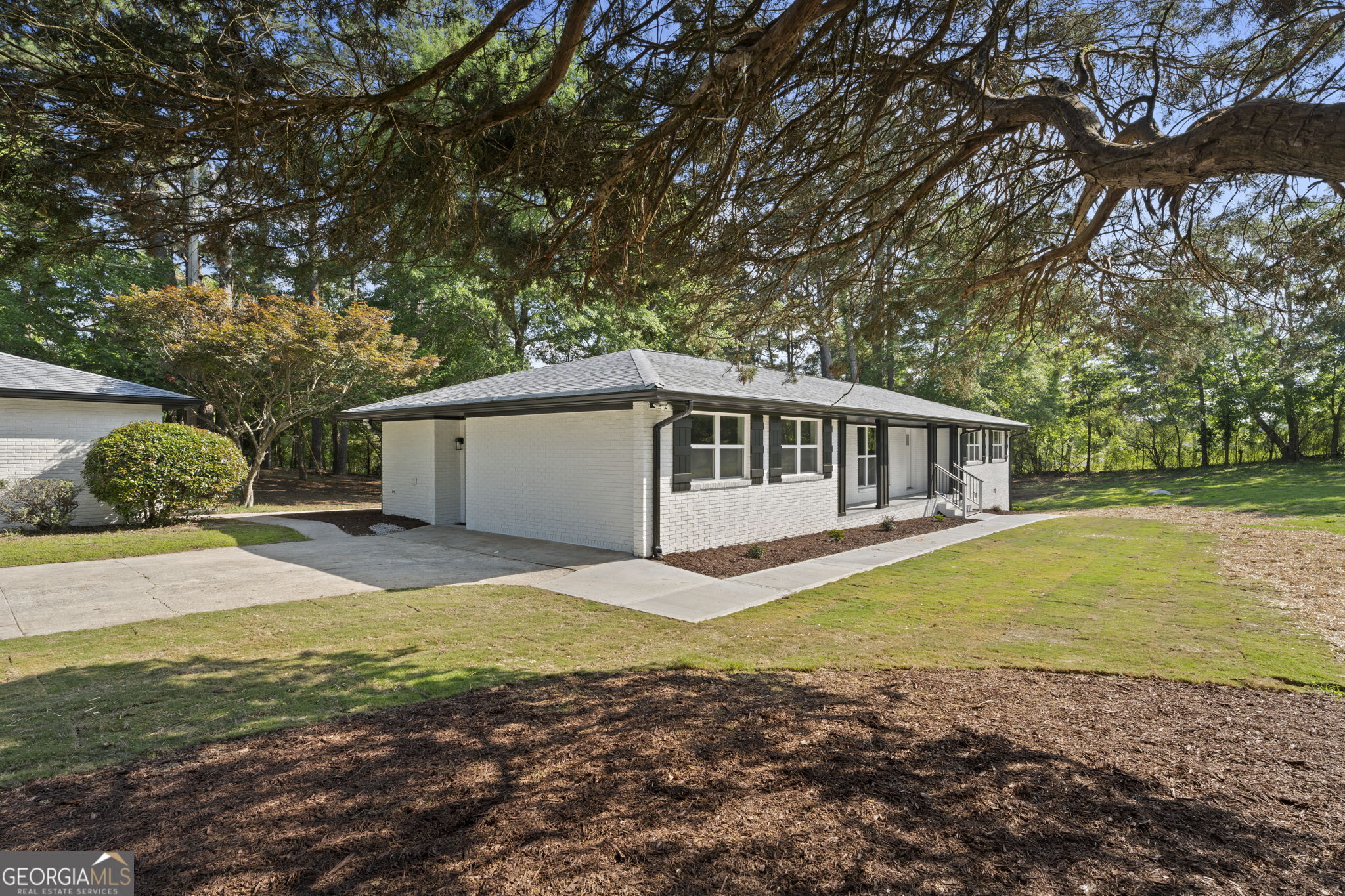 2604 Flat Shoals Road Southwest Conyers, GA 30094 - Photo 6 of 44 a view of a house with backyard and trees