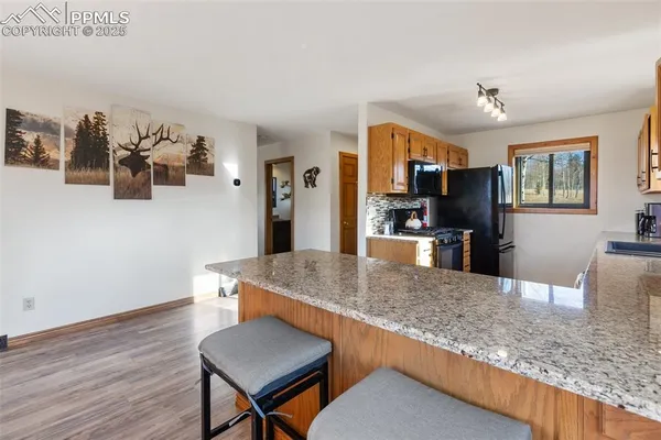 a living room with kitchen island furniture and a wooden floor