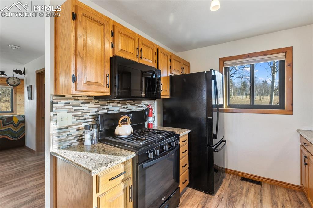 2387 Buffalo Ridge Road Como, CO 80456 - Photo 12 of 50 a kitchen with granite countertop a stove refrigerator and microwave