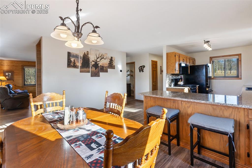 2387 Buffalo Ridge Road Como, CO 80456 - Photo 14 of 50 a living room with furniture a flat screen tv and kitchen view