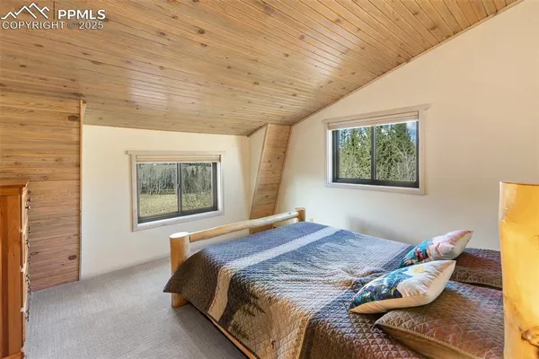 a bedroom with bed and a window