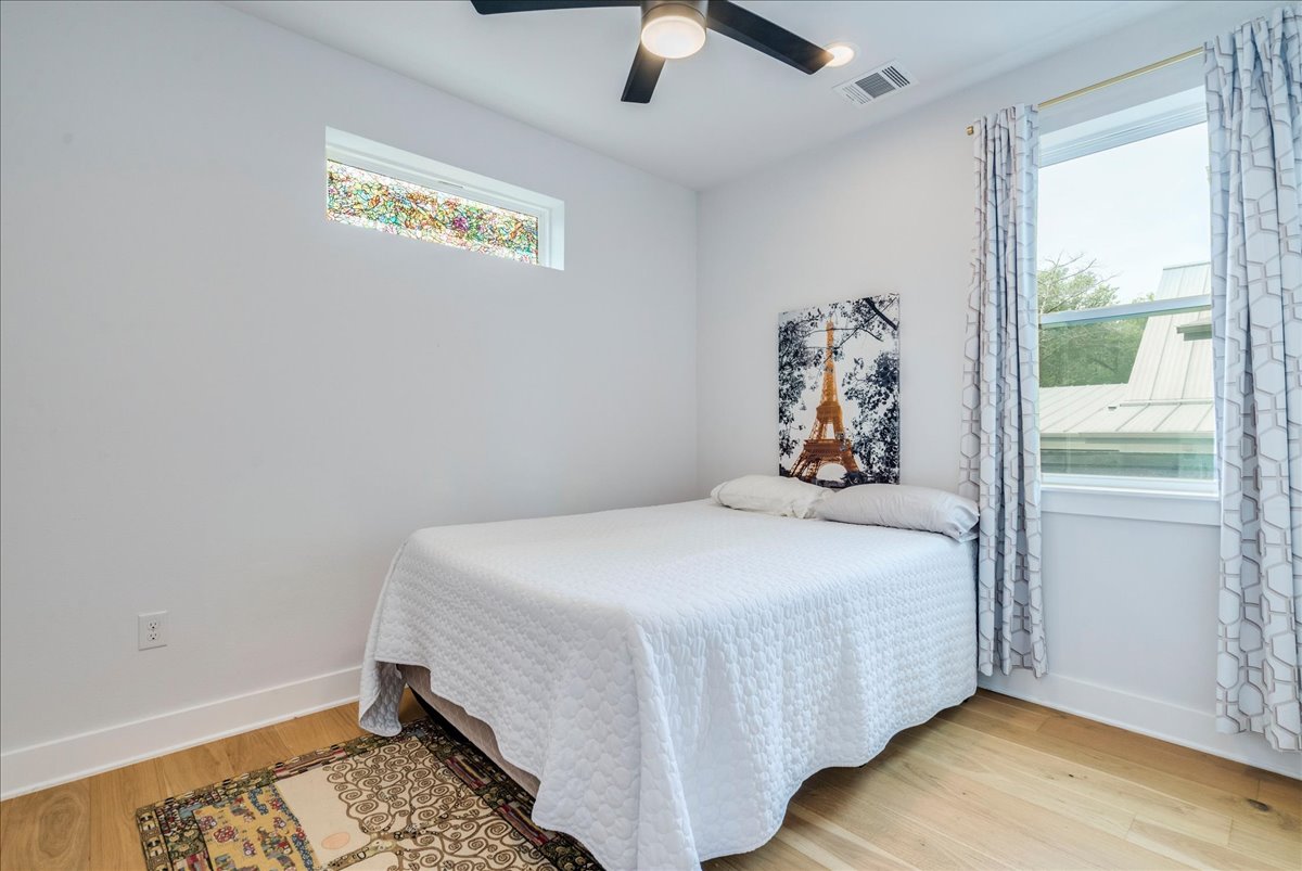 1214 Delano Street, Unit 1 Austin, TX 78721 - Photo 12 of 27 a bedroom with a bed and a window