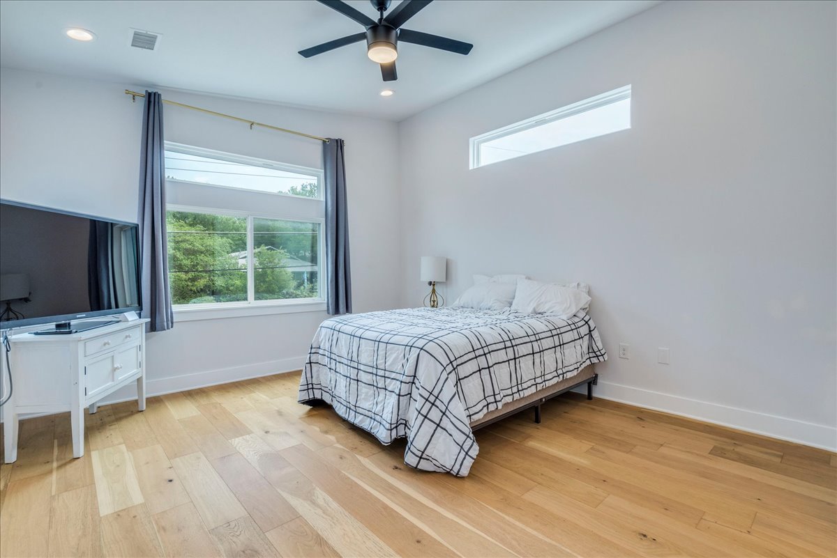 1214 Delano Street, Unit 1 Austin, TX 78721 - Photo 14 of 27 a bedroom with a bed and a flat screen tv