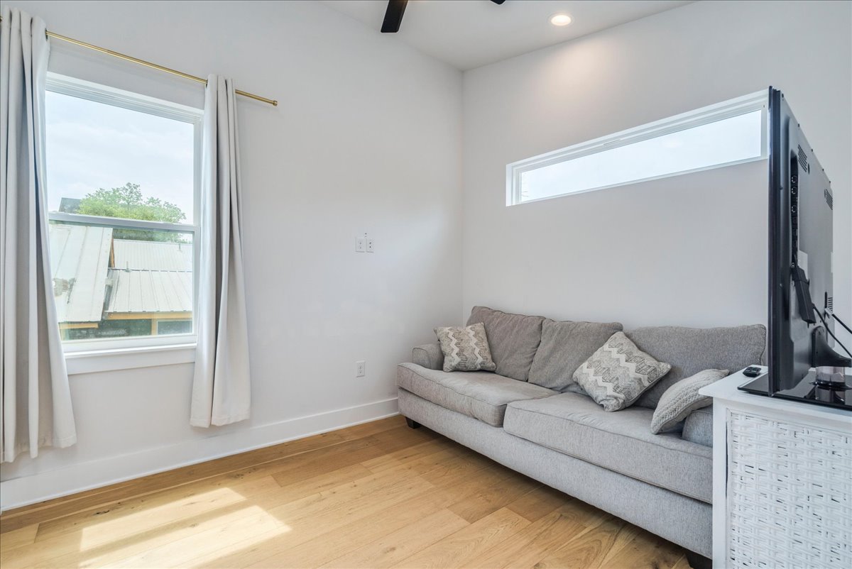 1214 Delano Street, Unit 1 Austin, TX 78721 - Photo 18 of 27 a living room with furniture and a window
