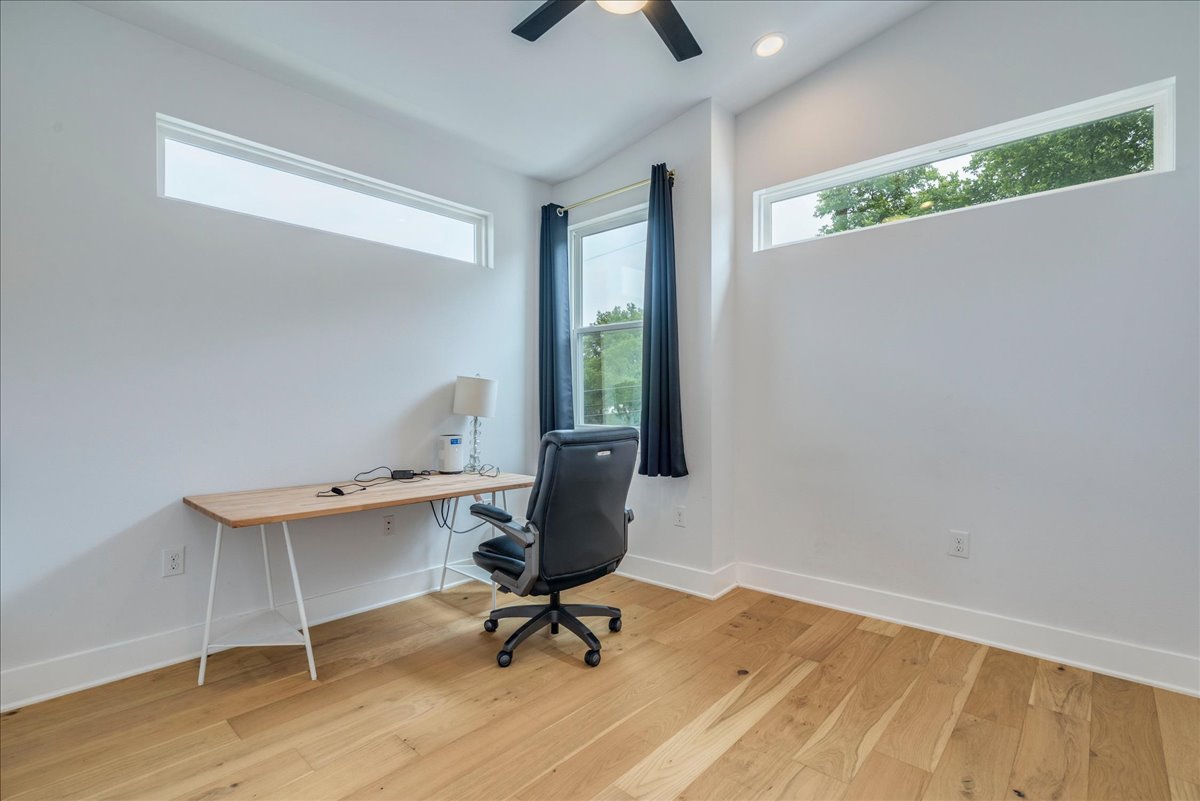 1214 Delano Street, Unit 1 Austin, TX 78721 - Photo 20 of 27 a view of a workspace with furniture and a window