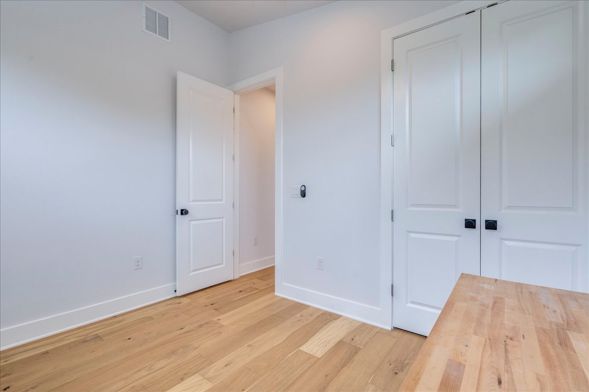 1214 Delano Street, Unit 1 Austin, TX 78721 - Photo 21 of 27 a view of an empty room and wooden floor