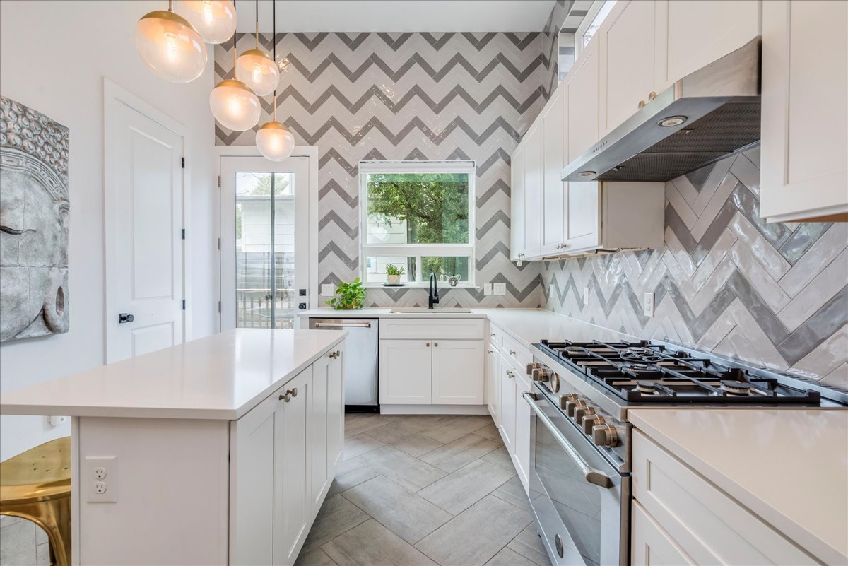 1214 Delano Street, Unit 1 Austin, TX 78721 - Photo 9 of 27 a kitchen with a stove a sink and a window