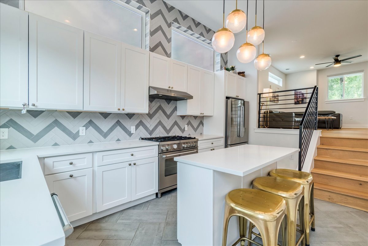 1214 Delano Street, Unit 1 Austin, TX 78721 - Photo 10 of 27 a kitchen with stainless steel appliances granite countertop a sink a stove and a refrigerator