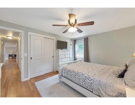 856 Maple Road Longmeadow, MA 01106 - Photo 12 of 27 a bedroom with a large bed and a chandelier