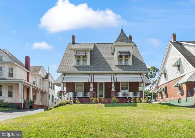 a front view of a building with a garden