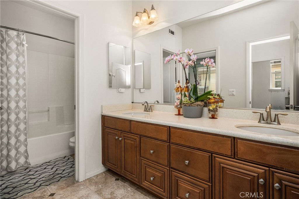 12652 Twin Peak Court Riverside, CA 92503 - Photo 32 of 55 a bathroom with a double vanity sink mirror and shower