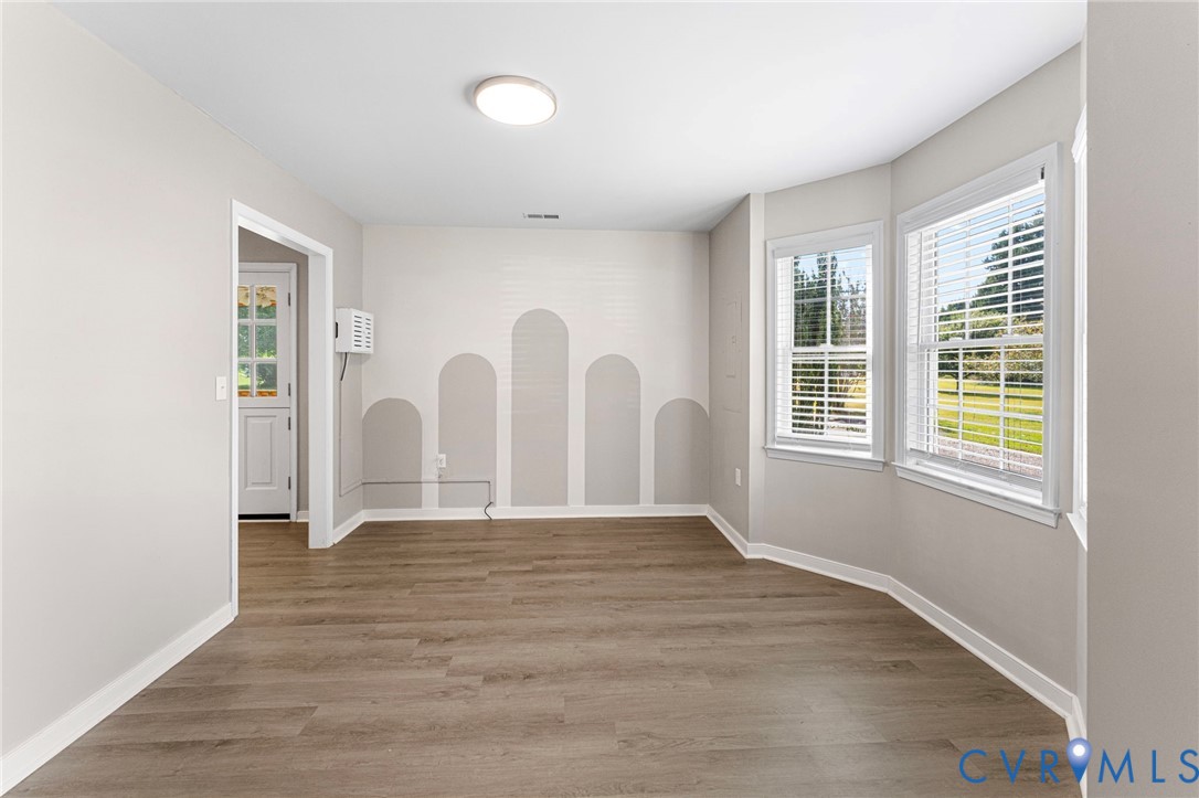 1146 Indian Valley Road Heathsville, VA 22473 - Photo 13 of 45 a view of an empty room with wooden floor and window