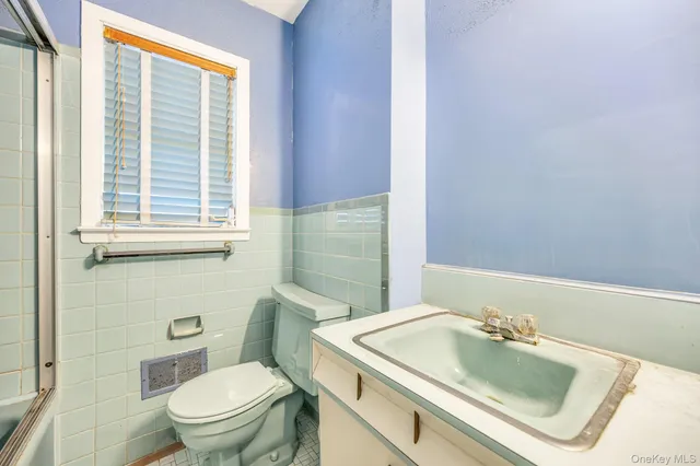 a bathroom with a sink toilet and mirror