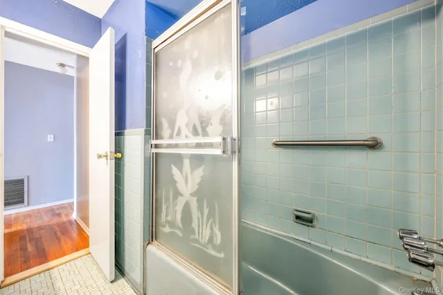 a bathroom with a bathtub and shower