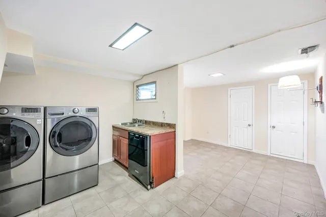 a view of a storage and utility room with washer and dryer