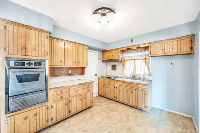 a kitchen with granite countertop a stove and a sink