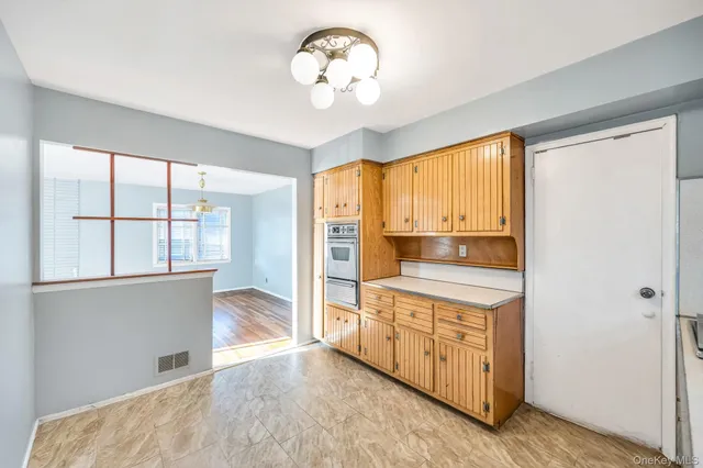 a open kitchen with granite countertop a stove and a wooden floors
