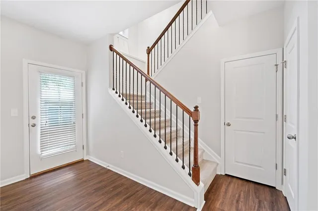 a view of an entryway with wooden floor and stairs