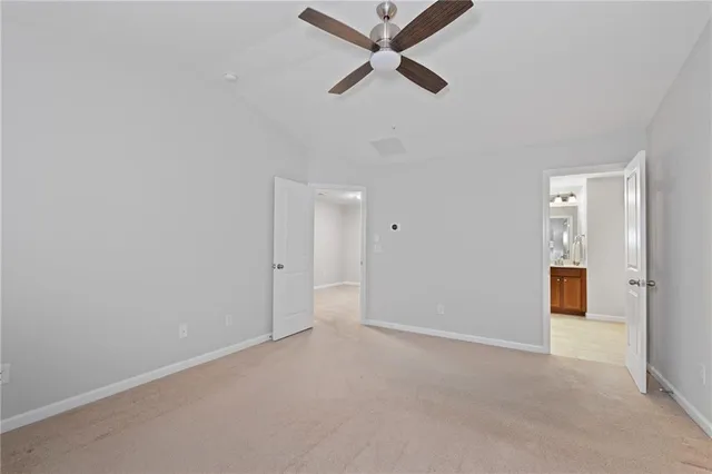 an empty room with closet and windows
