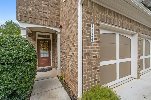 front view of a brick house with a large window