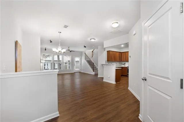a view of a living room with fireplace and wooden floor