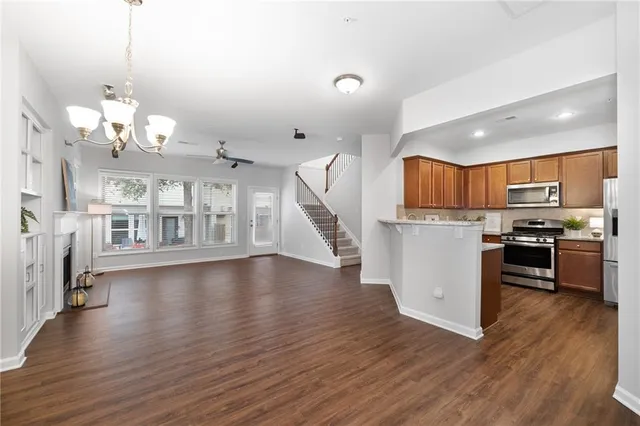 a view of a kitchen with stove and wooden floor