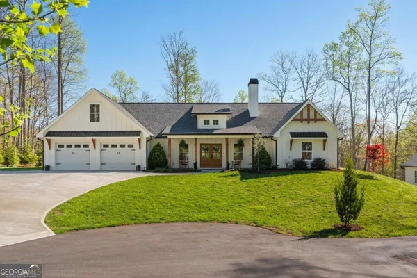 a front view of a house with a garden and yard