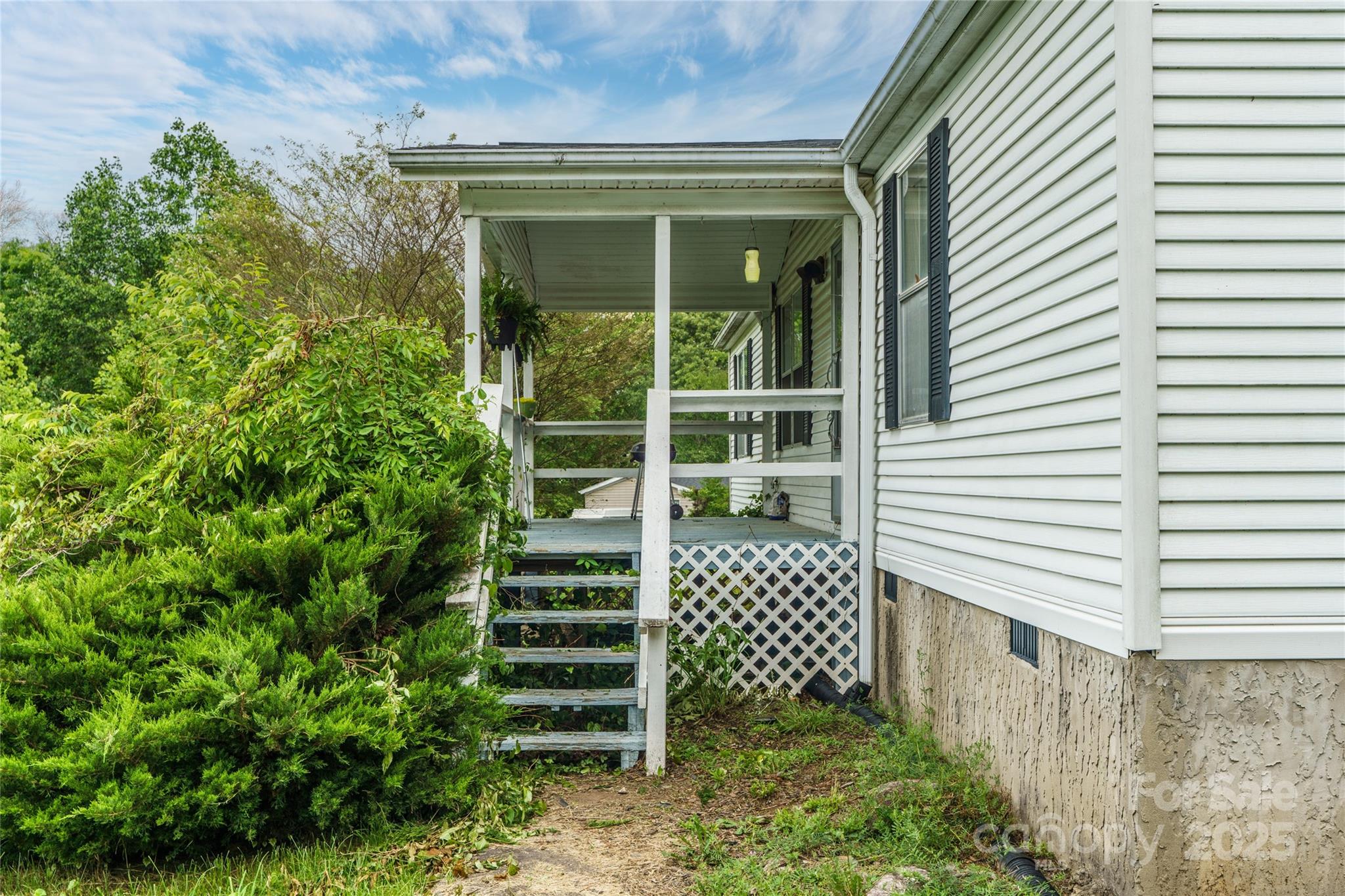 445 Old Holbert Road Hendersonville, NC 28792 - Photo 12 of 13 a view of a house with a yard and wooden fence