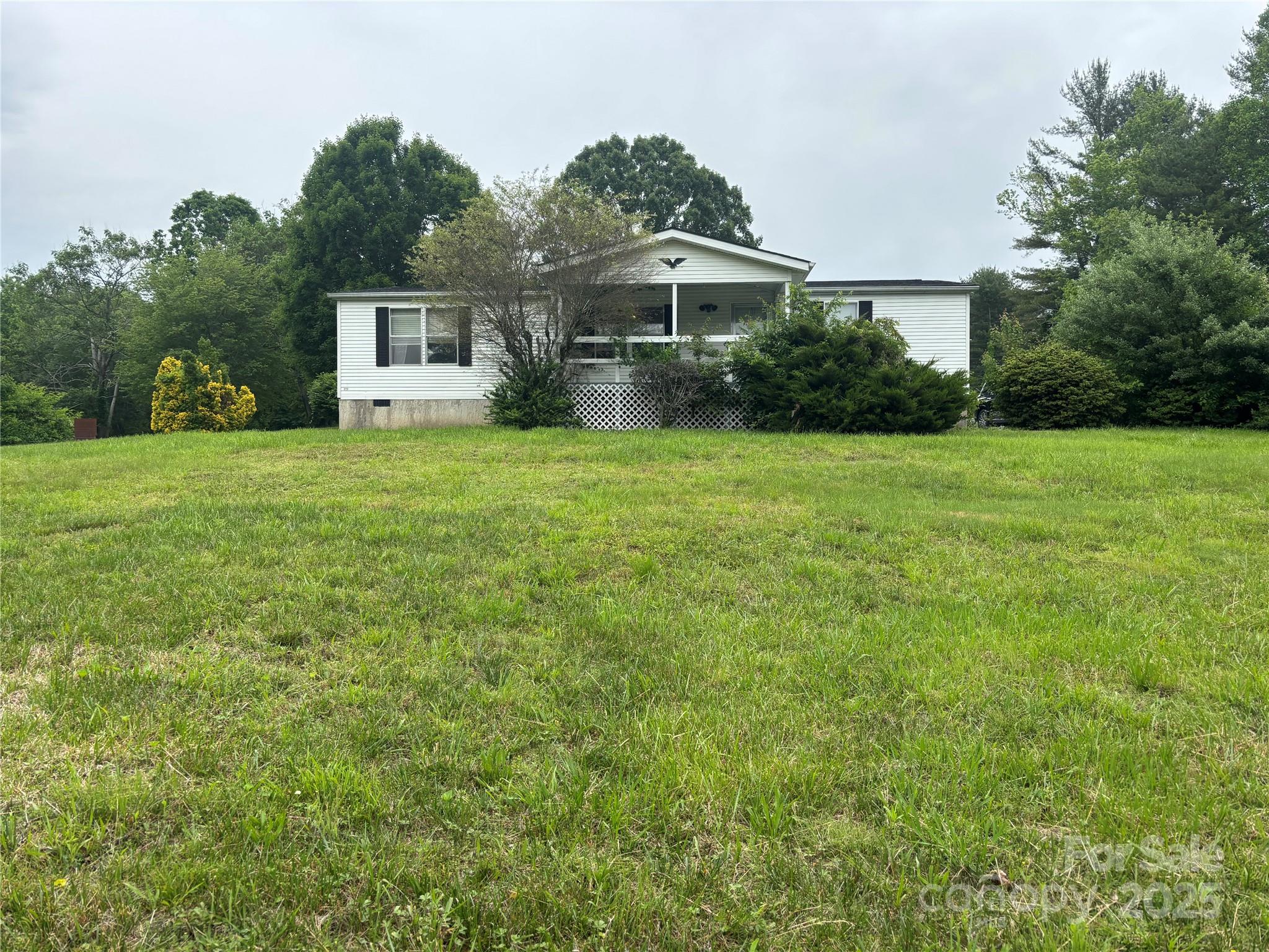 445 Old Holbert Road Hendersonville, NC 28792 - Photo 2 of 13 a front view of a house with a garden
