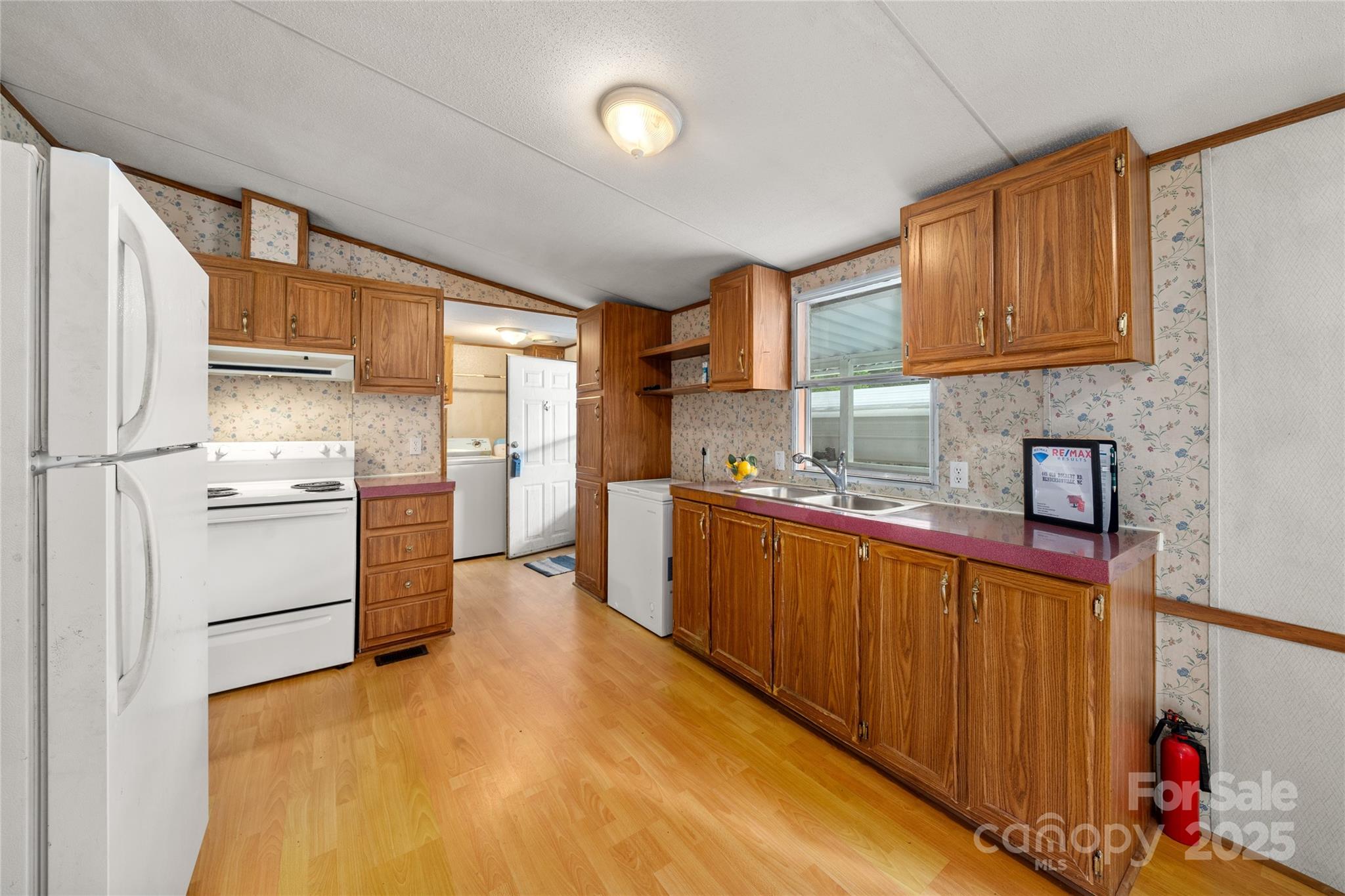445 Old Holbert Road Hendersonville, NC 28792 - Photo 7 of 13 a kitchen with stainless steel appliances granite countertop a refrigerator sink and cabinets