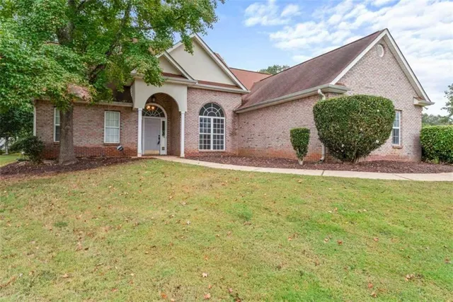 a front view of a house with yard