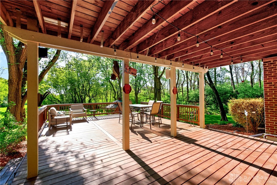 330 South Alpha Bellbrook Road Bellbrook, OH 45305 - Photo 59 of 87 An inviting deck extends into a lush, private yard, perfect for outdoor enjoyment.