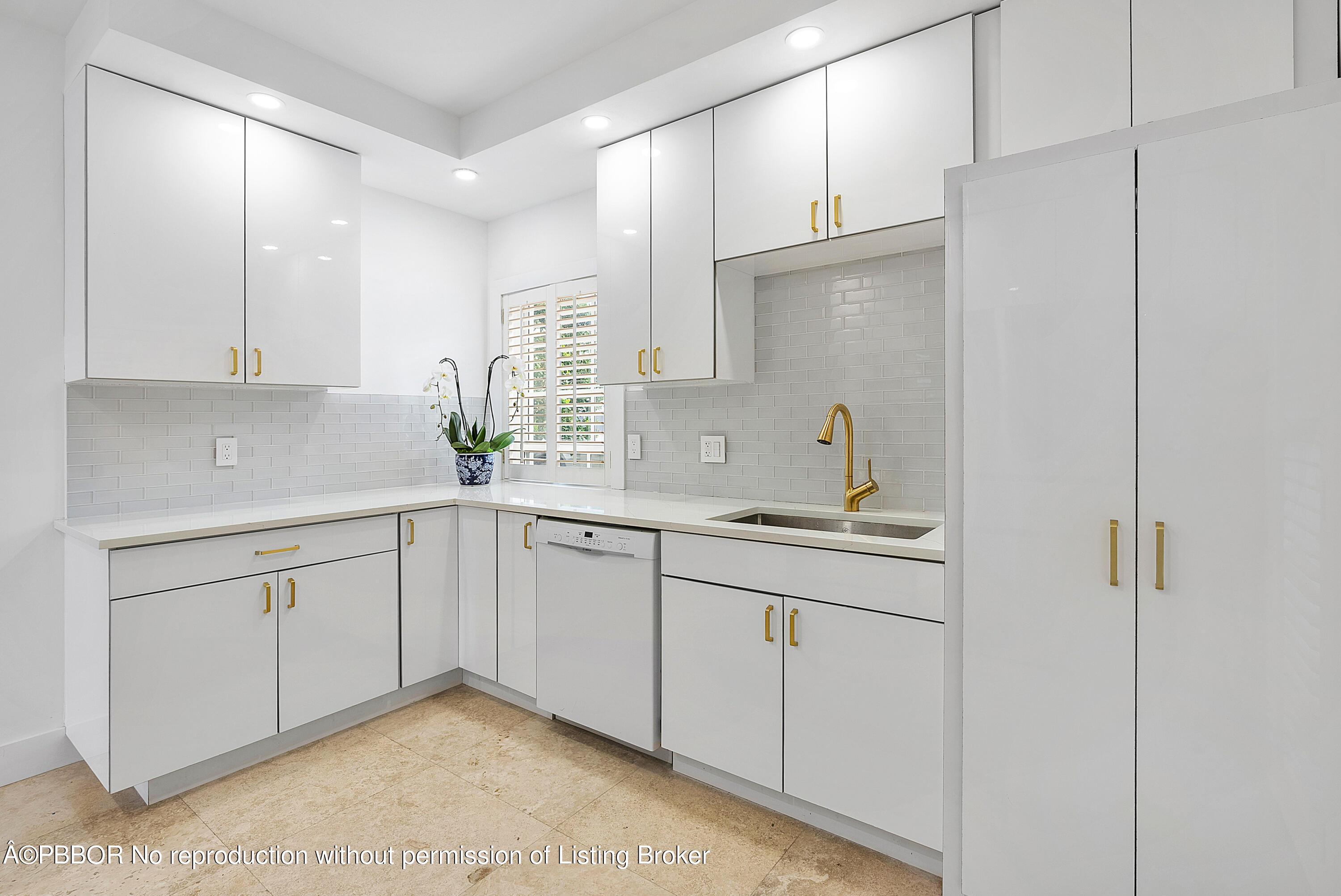 2180 Ibis Isle Road, Unit 5 Palm Beach, FL 33480 - Photo 14 of 39 a kitchen with a sink cabinets and window