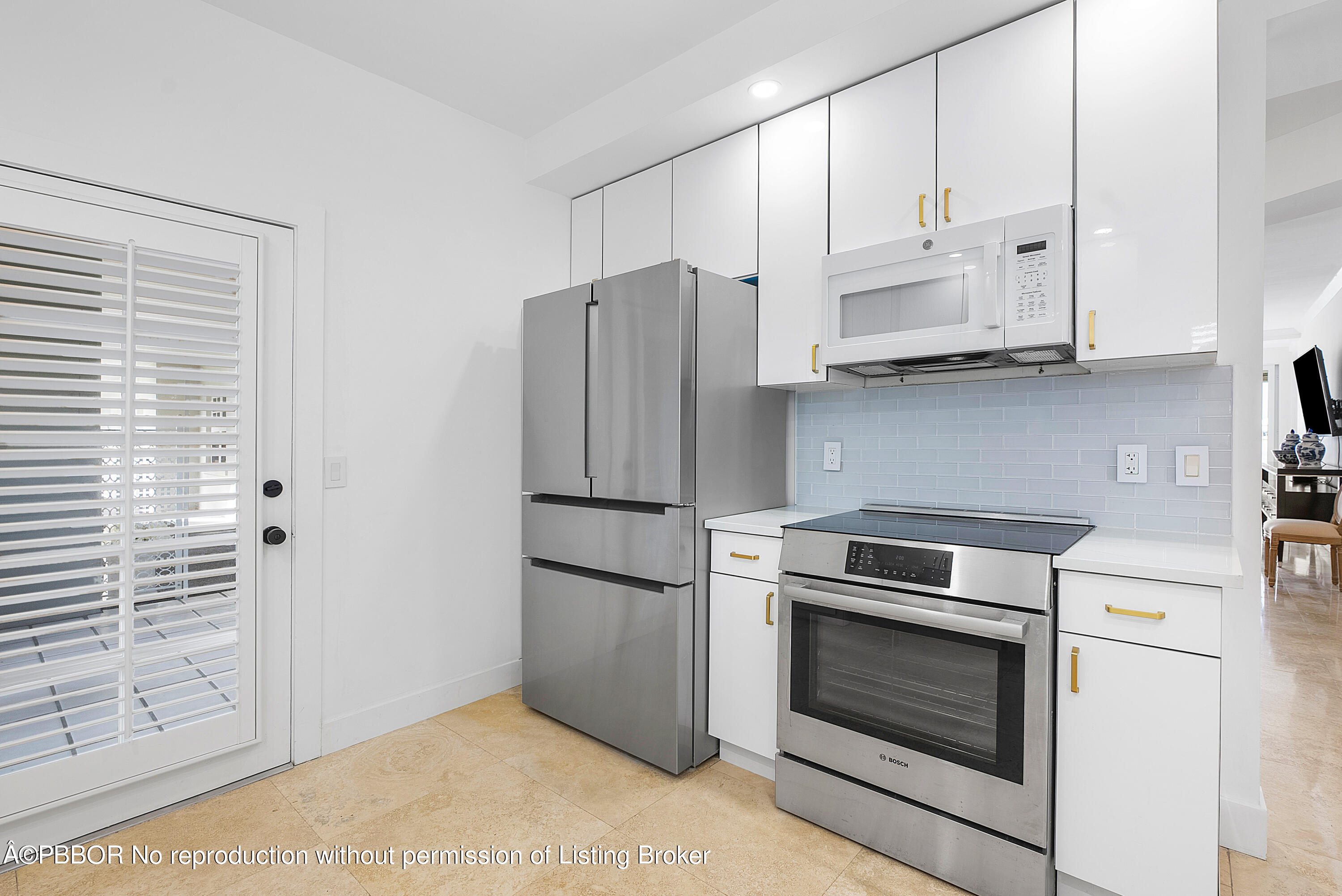 2180 Ibis Isle Road, Unit 5 Palm Beach, FL 33480 - Photo 15 of 39 a kitchen with stainless steel appliances white cabinets and a refrigerator