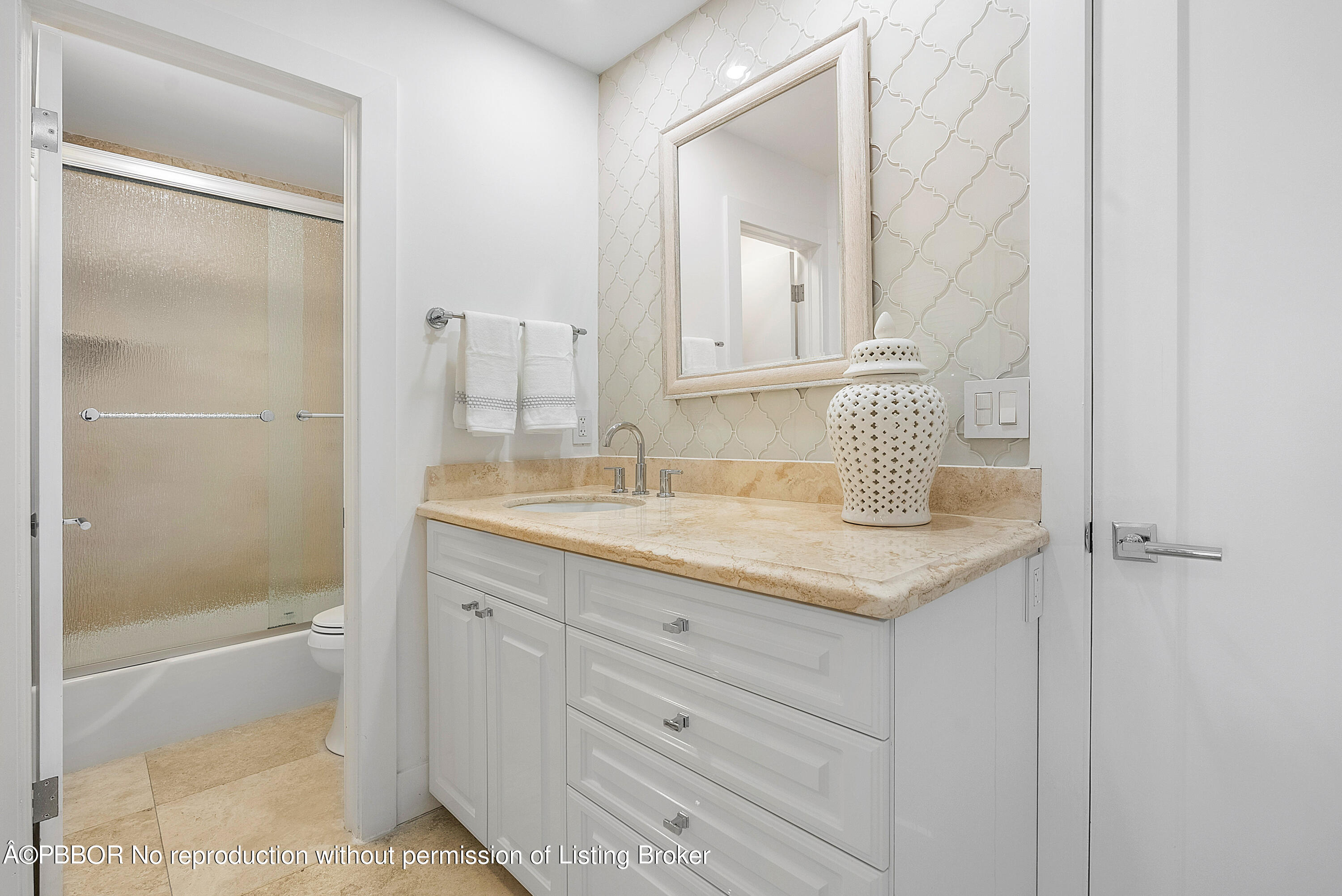 2180 Ibis Isle Road, Unit 5 Palm Beach, FL 33480 - Photo 21 of 39 a bathroom with a granite countertop sink and a mirror