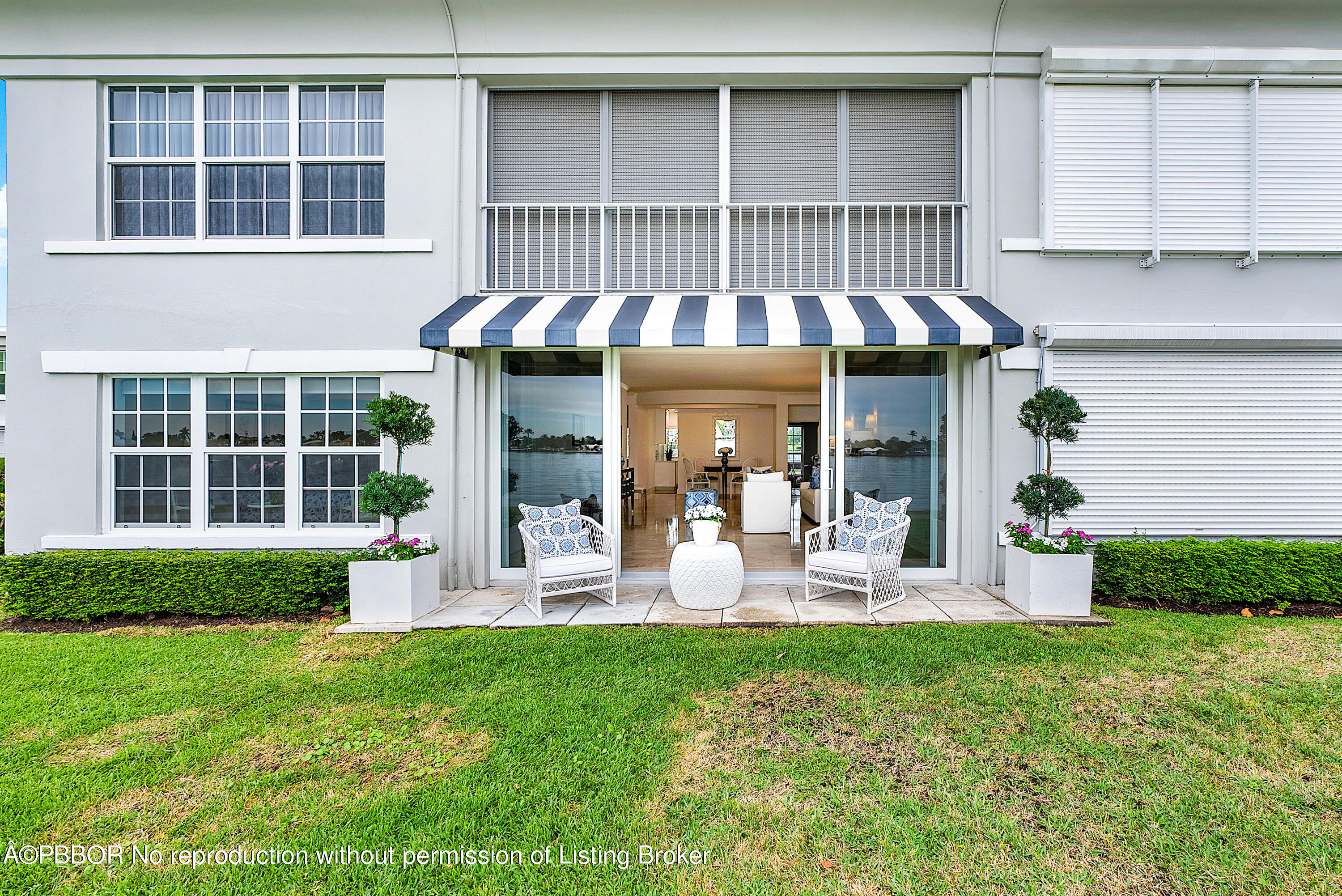 2180 Ibis Isle Road, Unit 5 Palm Beach, FL 33480 - Photo 23 of 39 a front view of a house with a garden and porch